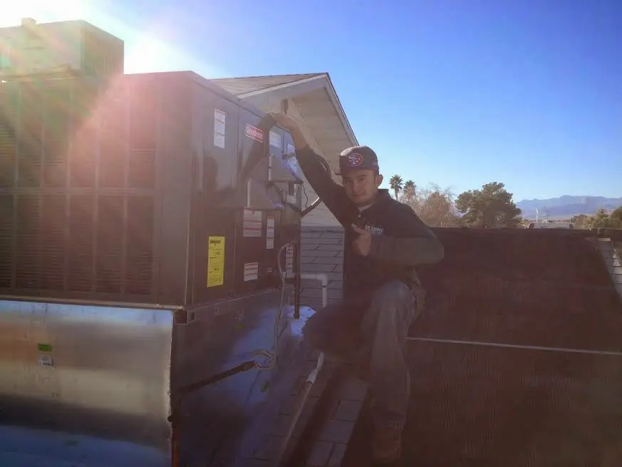 HVAC technician performing AC Tune-Up on a rooftop unit in Emmaus